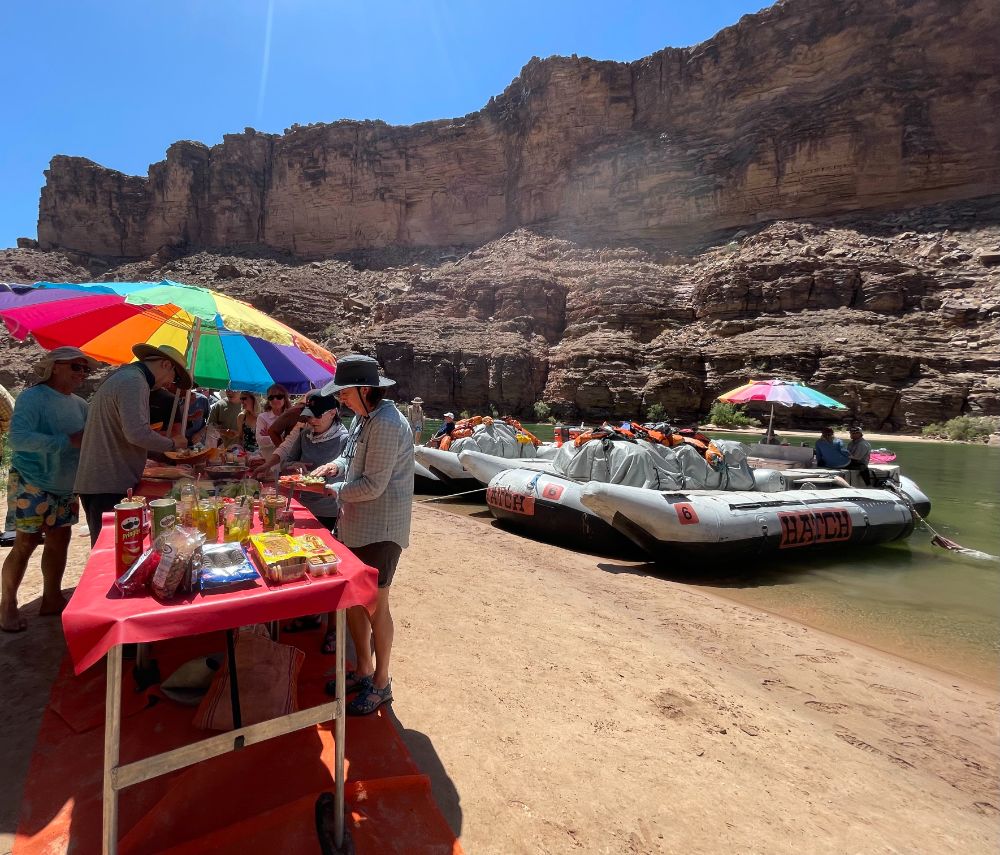 hatch guests enjoying a lunch by the colorado river
