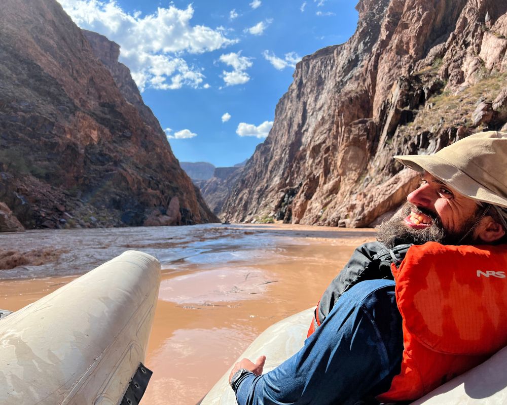 Guy smiling on Hatch Raft while on a Grand Canyon rafting tour