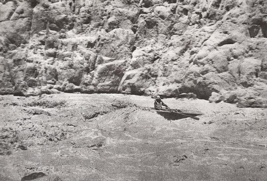 man running raft through rapid in grand canyon in 1030s