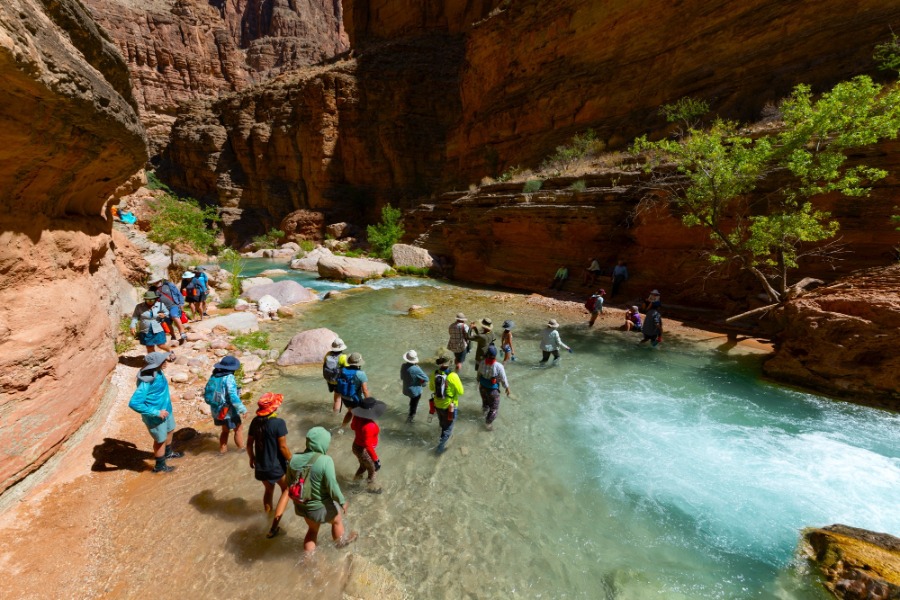 people walking through a shallow area of the colorado river