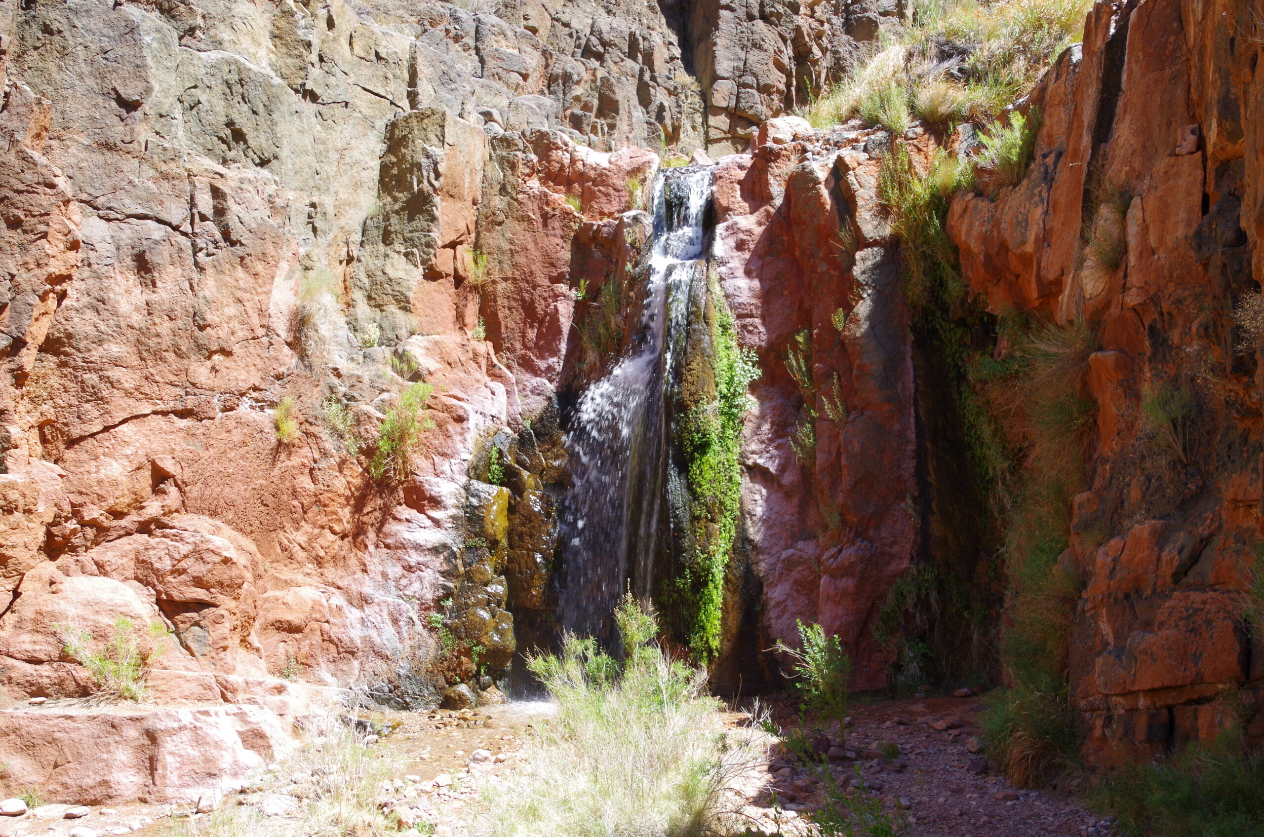 Grand Canyon's Stone Creek Falls tumbling over blocky red rocks. Photo credit: John Dillon