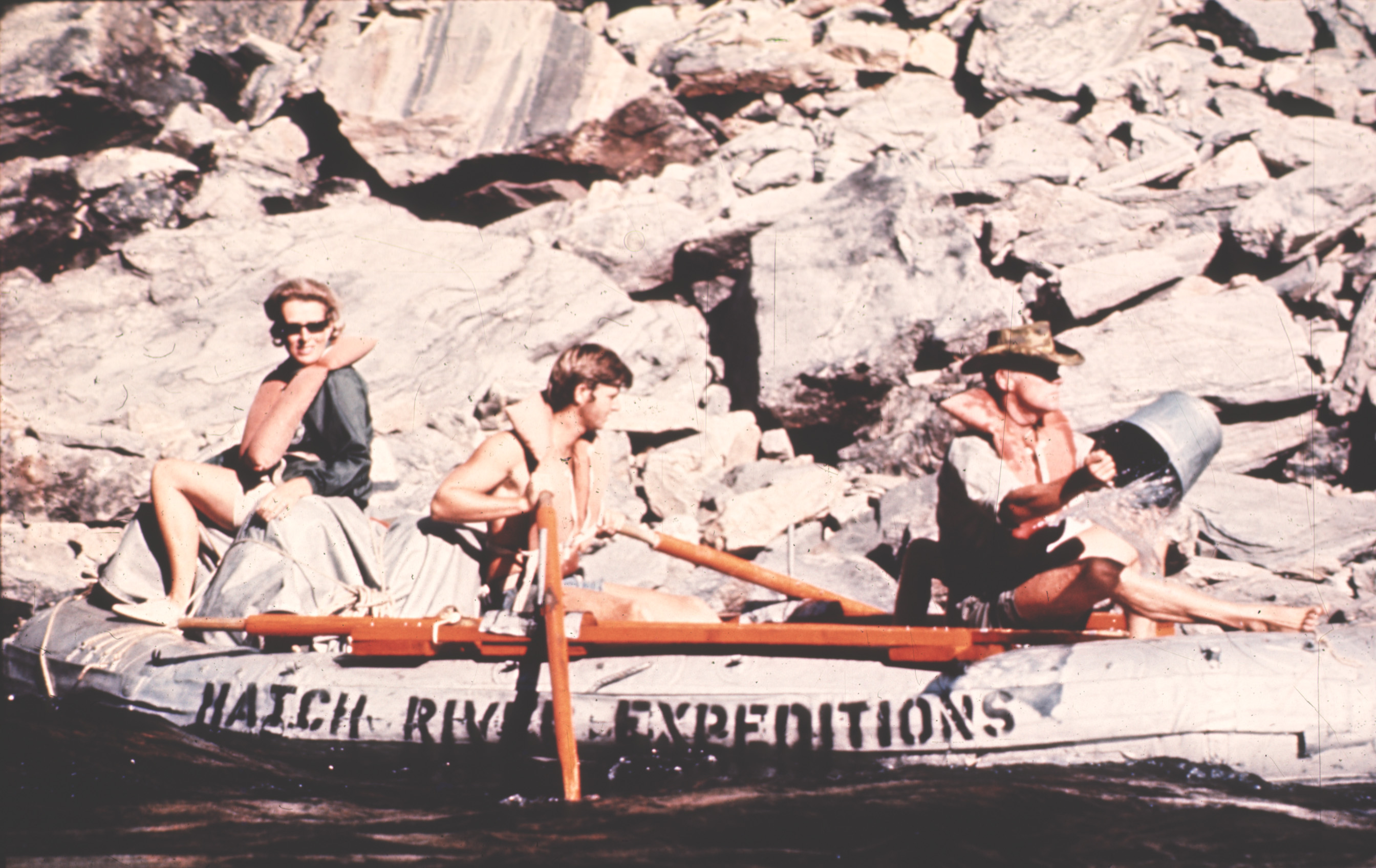one guide rowing a Hatch River Expeditions oar powered raft with two guests during the 1970s