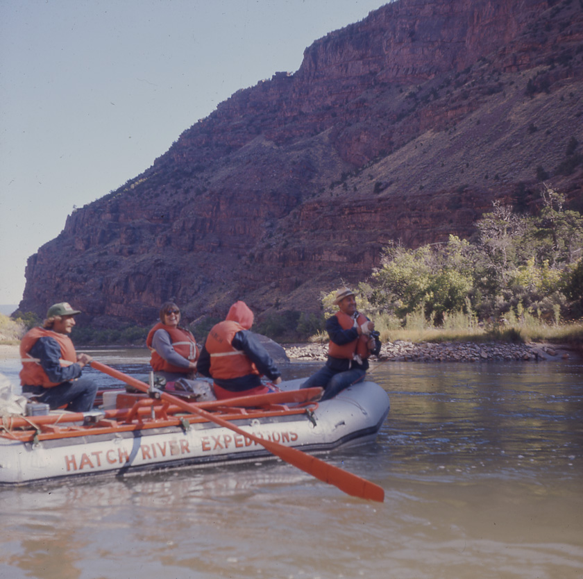 Guests and a guide on a vintage Hatch River Expeditions oar-powered rubber raft in the 1980's.