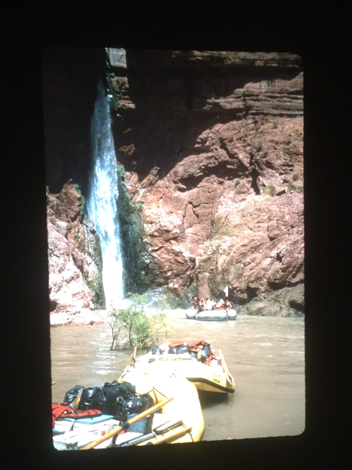 Boats at the base of Deer Creek falls. The swimming hole at the base of this waterfall is normally surrounded by dry land and accessible only by foot. 