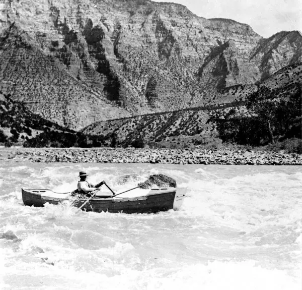 Nathaniel Galloway displaying his stern first river rafting technique with Split Mountain in the background in the 1920s