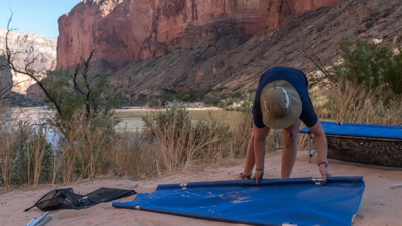 People setting up cots on Grand Canyon Trip with Hatch River Expeditions