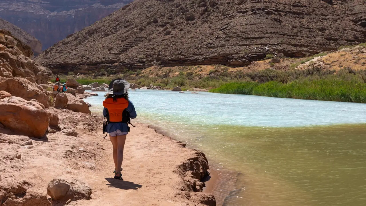 Person hiking next to the Little Colorado River on Hatch River Expeditions Trip