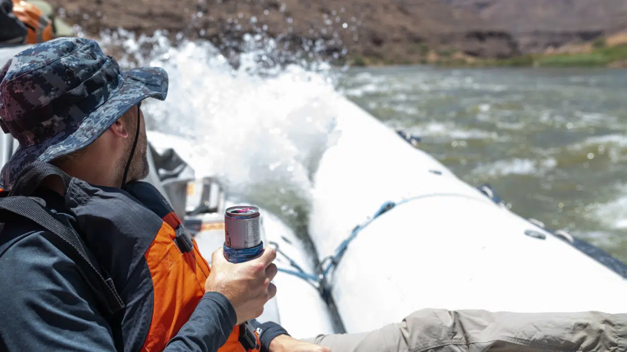 person holding drink while rafting colorado river with Hatch River Expeditions