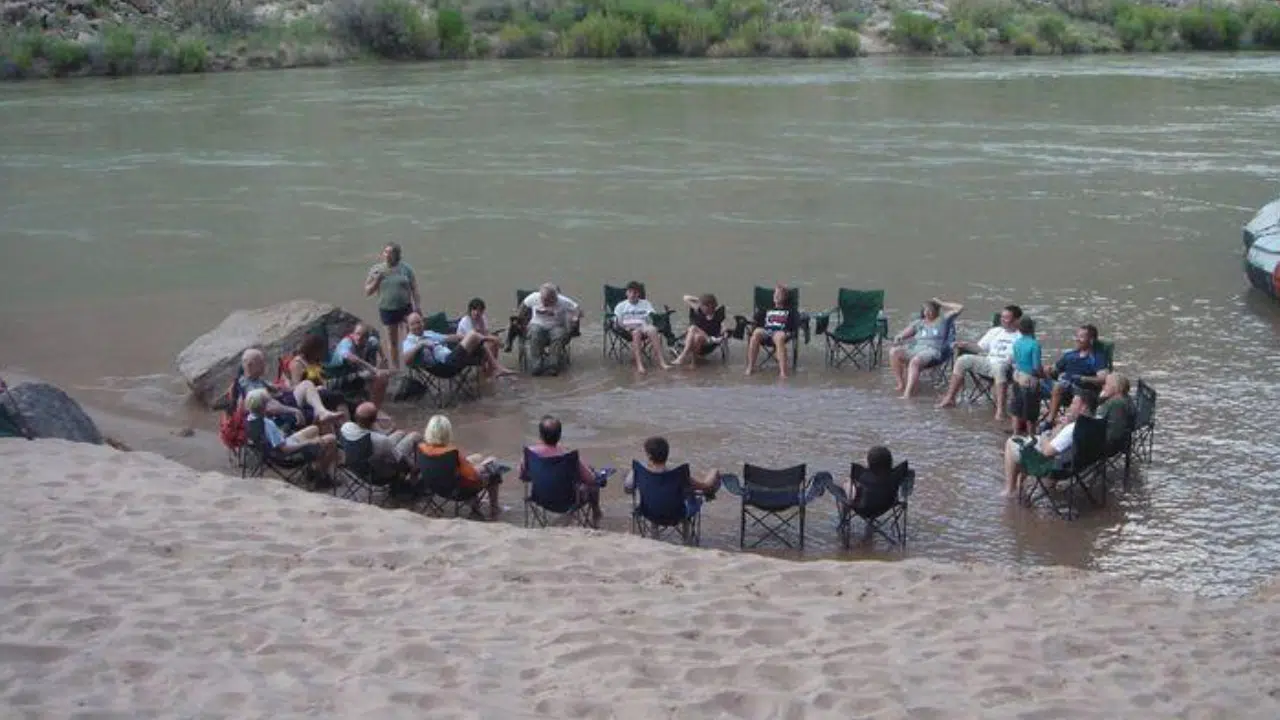 People in Colorado River sitting in chairs on Hatch River Expedition Trip