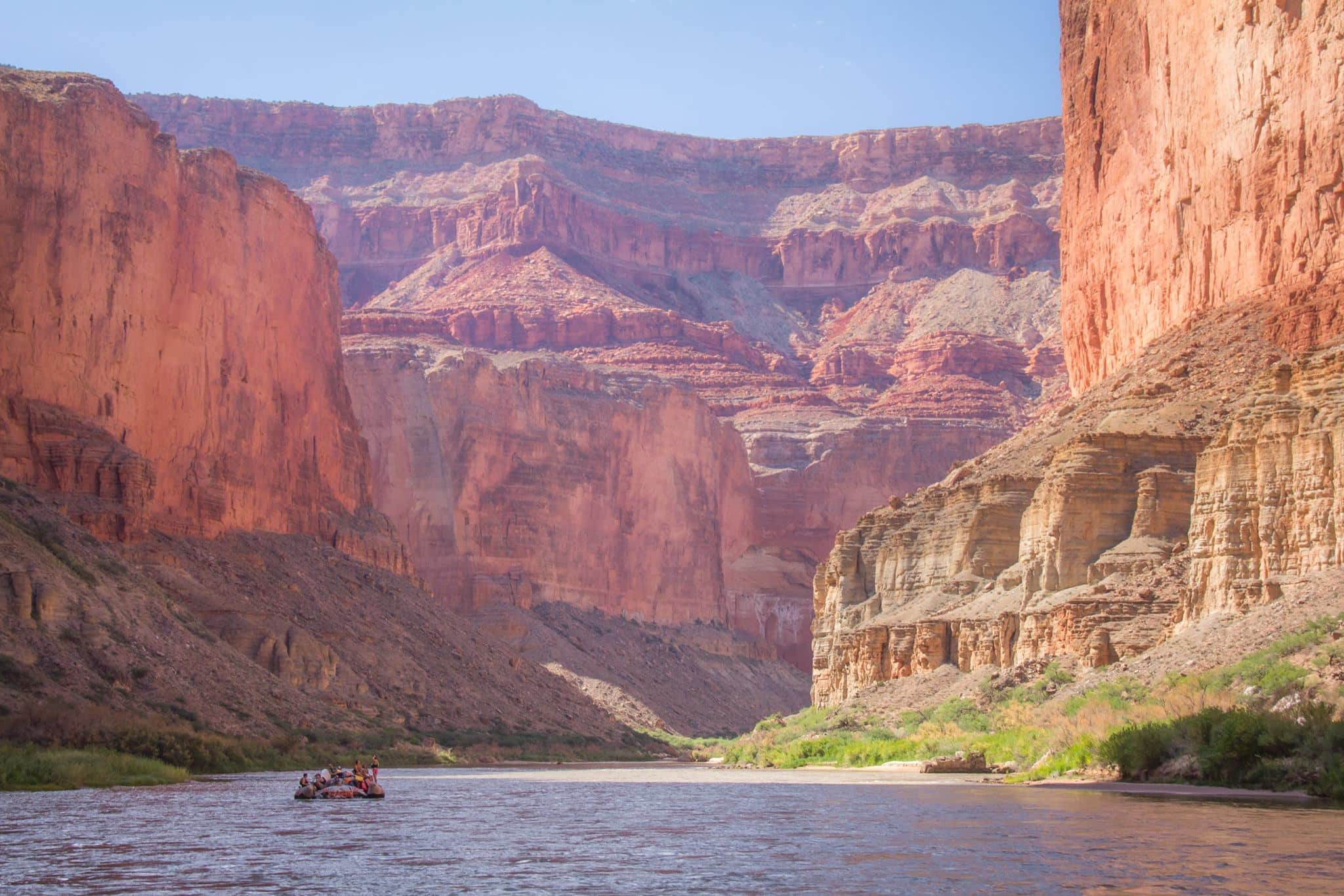 Photo of Hatch raft dwarfed by the walls of the canyon, showing why 1 or 2 day rafting trips in Grand Canyon are difficult. Photo credit: R. Ben Lehman.