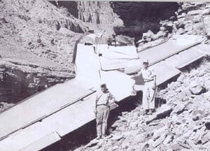 two men standing in front of TWA2/UAL718 crash wreckage in Grand Canyon