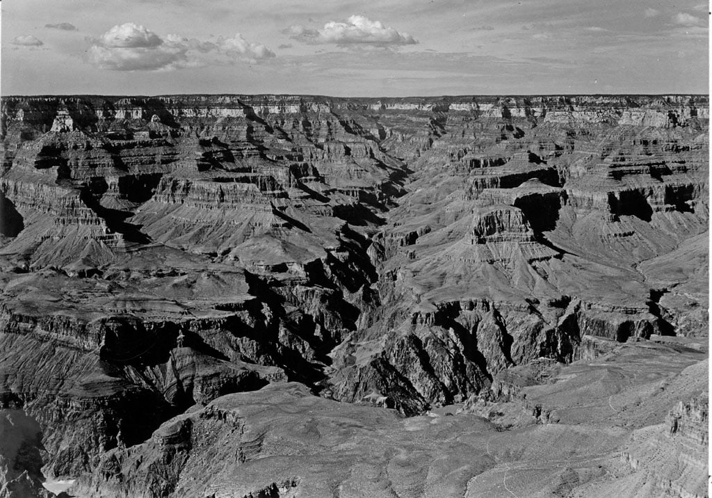 View in 1929 from Yavapai Point on the South Rim of Grand Canyon. Suspension trail bridge at lower right center. Phantom Ranch at lower end of Bright Angel Canyon. There are plenty of stories of ghosts in Grand Canyon, just in time for Halloween. GCNPS photo by George Grant June 25, 1929.