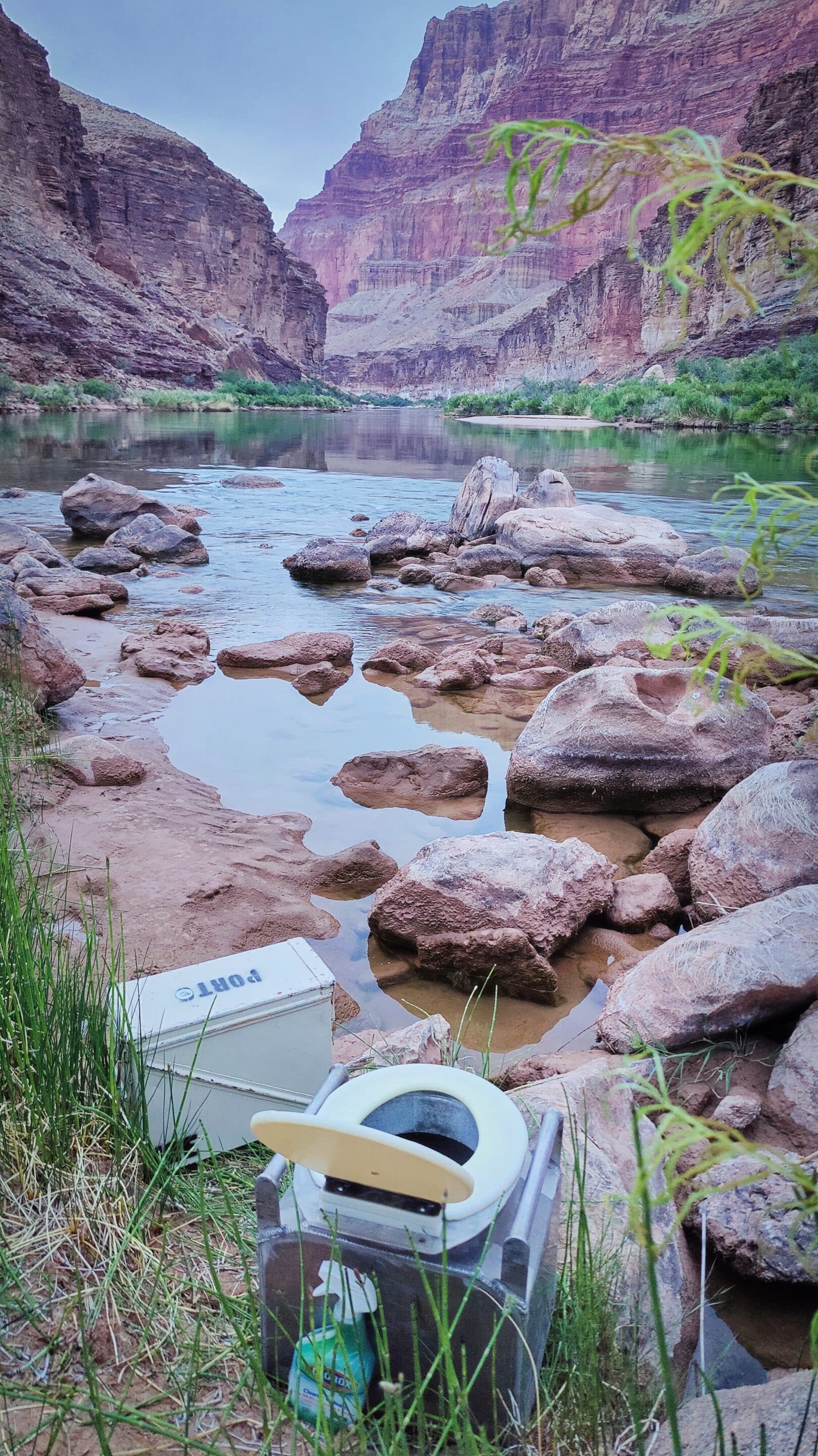 Photo of a groover toilet for a river rafting trip in Grand Canyon looking out over a view of the river. One of the places you can take care of your period on the river.