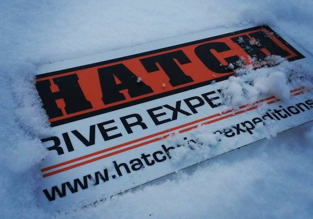 Hatch River Expeditions sign lying in the snow. Holidays are perfect for planning a Grand Canyon rafting trip.