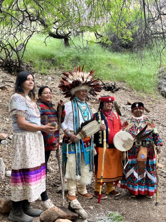 Havasupai tribal members dressed in traditional regalia stand in Havasupai Gardens in Grand Canyon during the 2023 ceremony to rename the area formerly known as Indian Garden