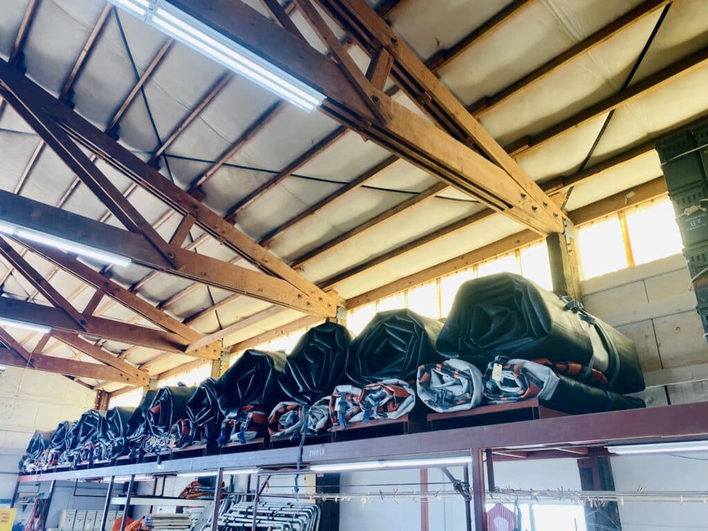 Motor boat rigs rolled up and placed on shelf at the end of winter work. River rafting off season at Hatch River Expeditions.