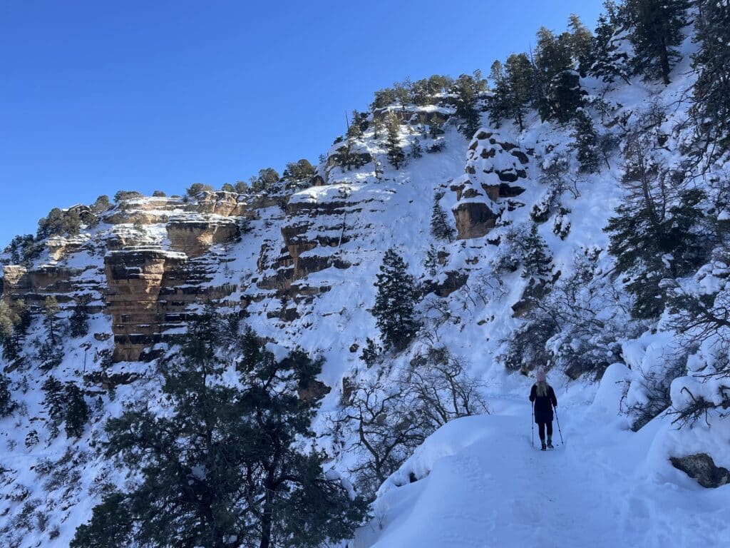 Woman hiking snow covered Bright Angel Trail