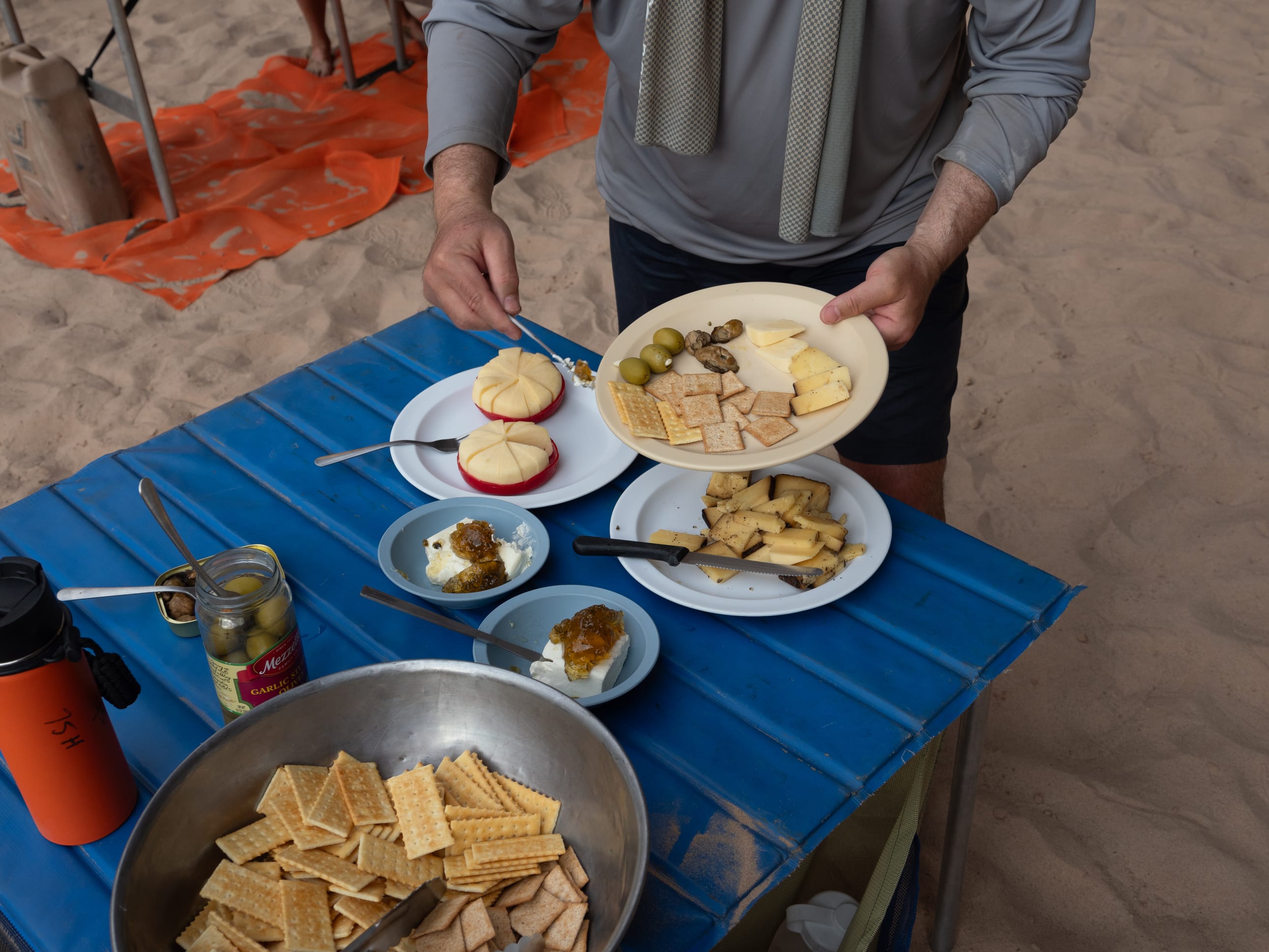 A table spread with a variety of cheeses, crackers, and pickled items for a pre-dinner appetizer. Photo credit: Amy Horn. 