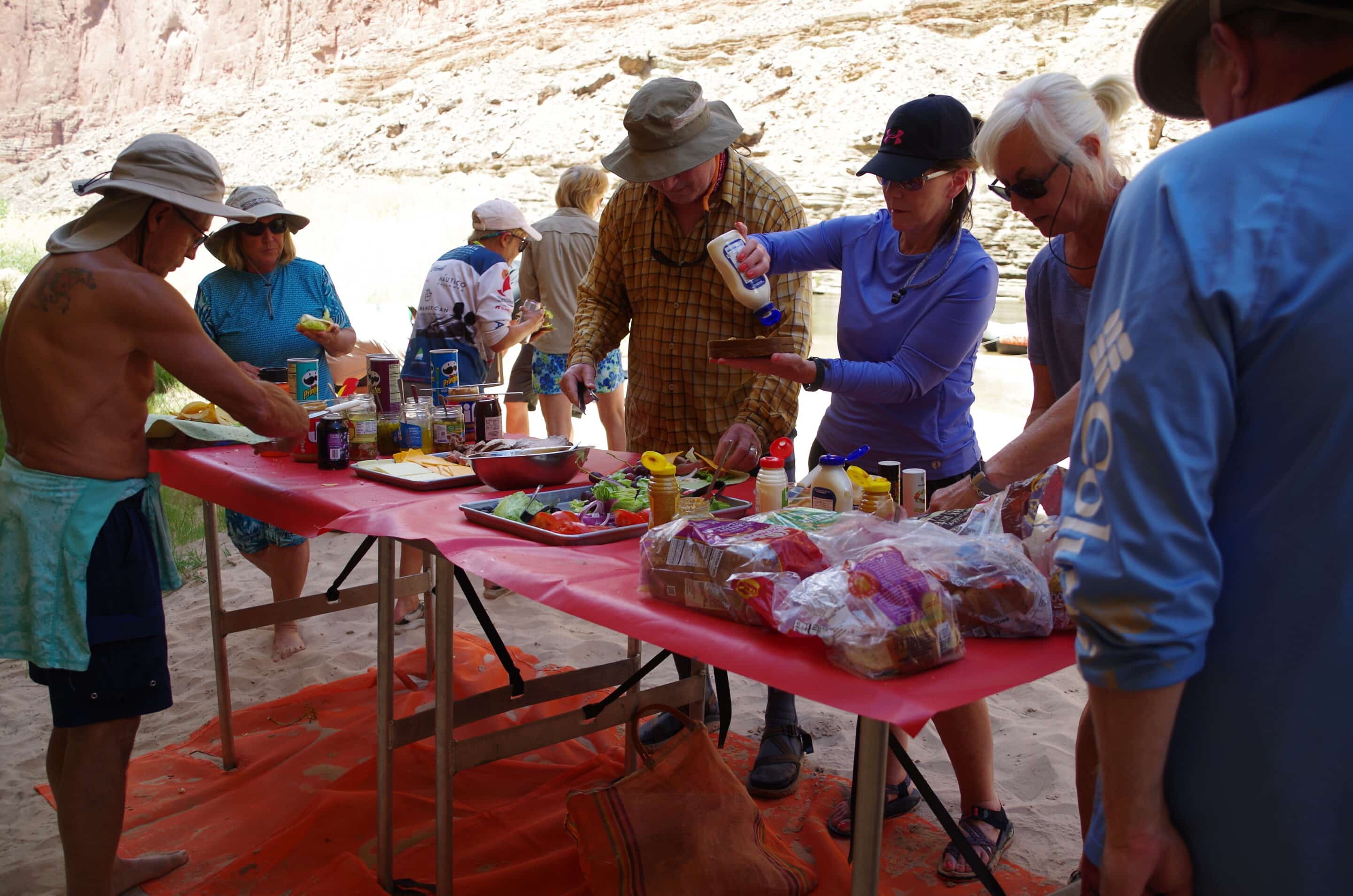 Hatch guests gathered around the lunch table making sandwiches. Photo credit: John Dillon. 