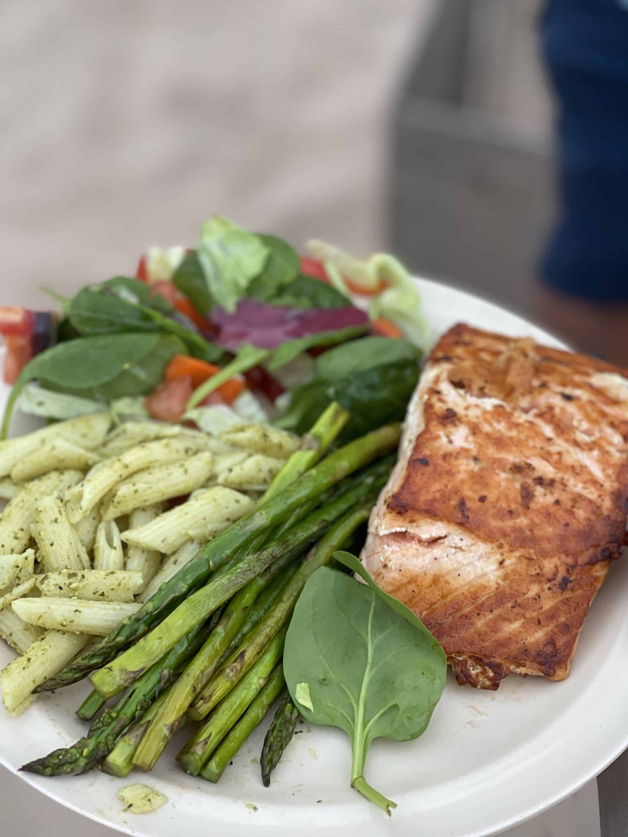 A Hatch dinner consisting of grilled salmon, steamed asparagus, pesto pasta, and a green salad. Photo credit: John Dillon.