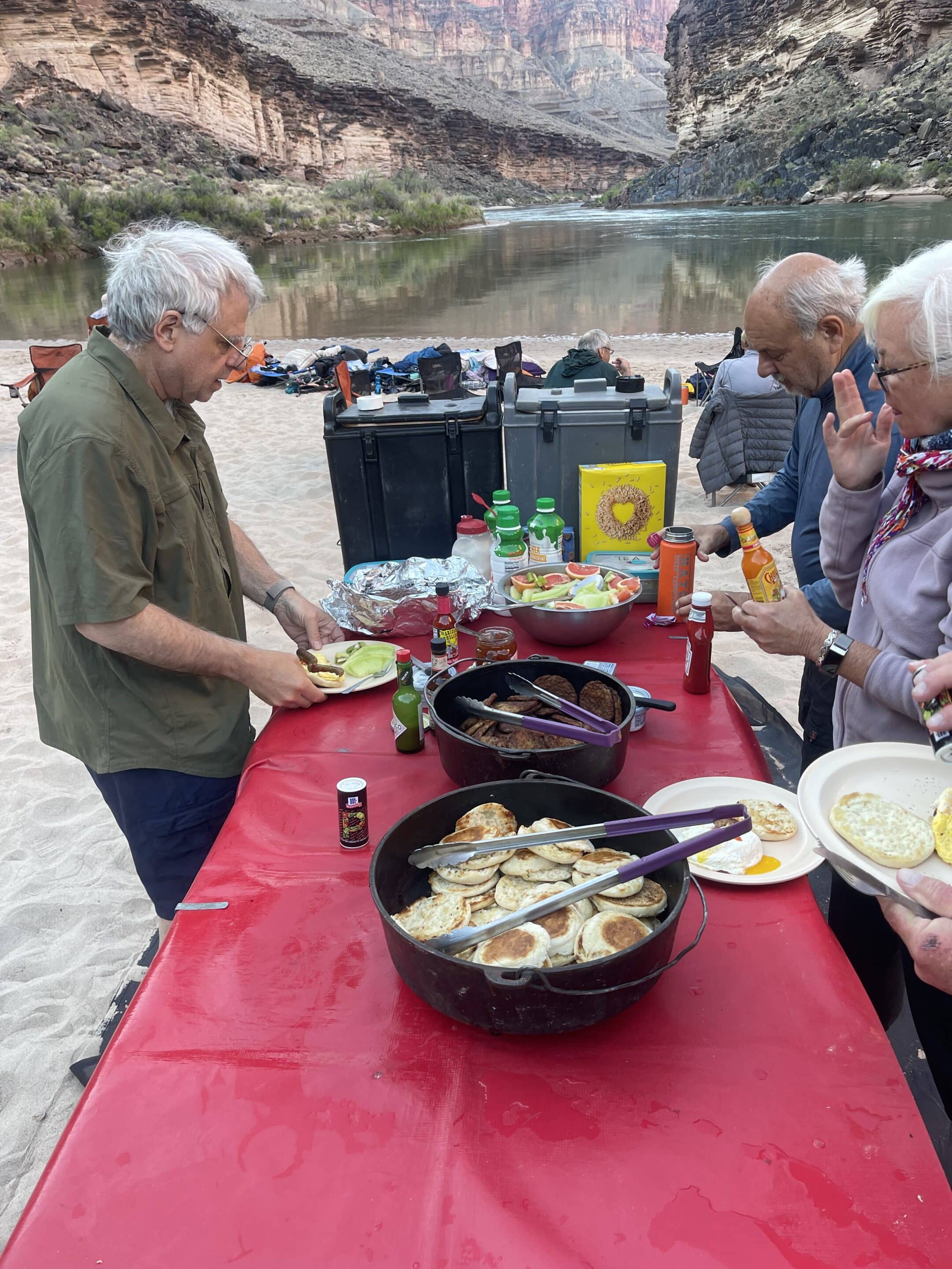 Breakfast table on a Hatch river trip with English muffins, sausage patties, fresh fruit, cereal, and other items. Photo credit: John Dillon. 