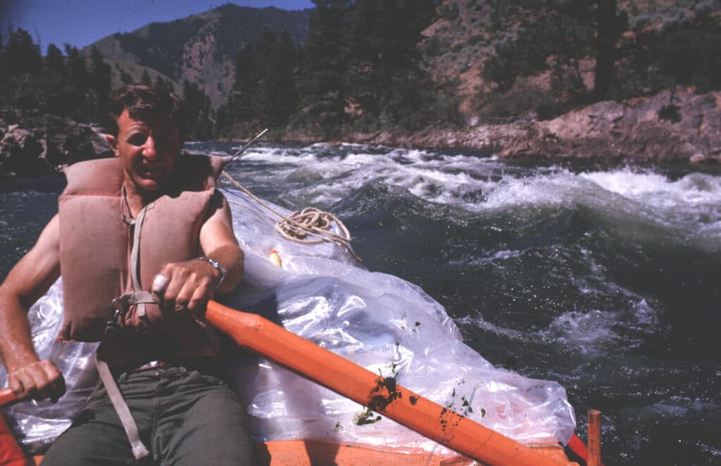 Don Hatch running rapid wearing foam lifejacket