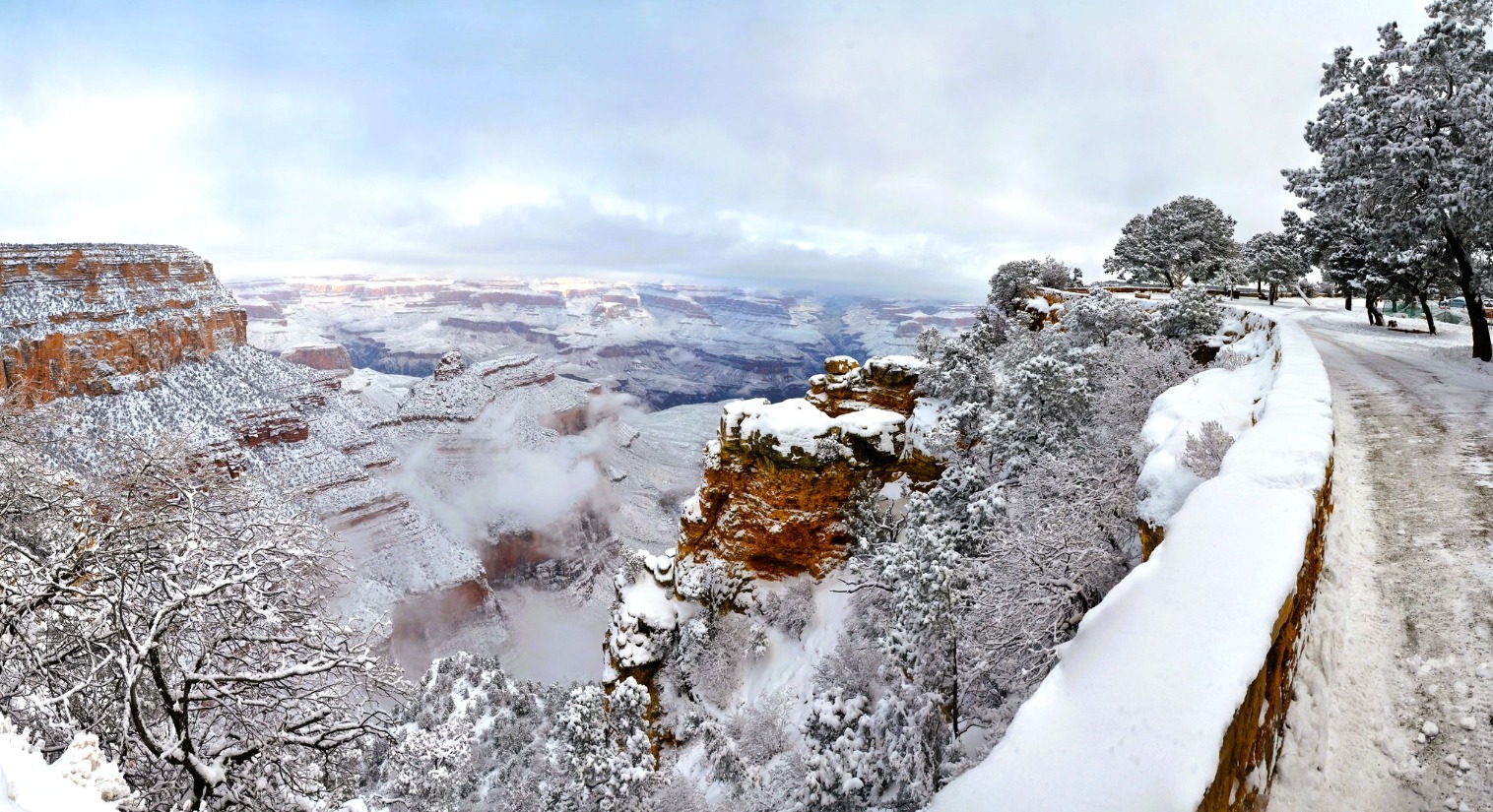 The Grand Canyon covered in snow and low clouds. Shows a good place for winter pastimes for those who like to white water river raft in the summer. Photo credit to Grand Canyon National Park Service