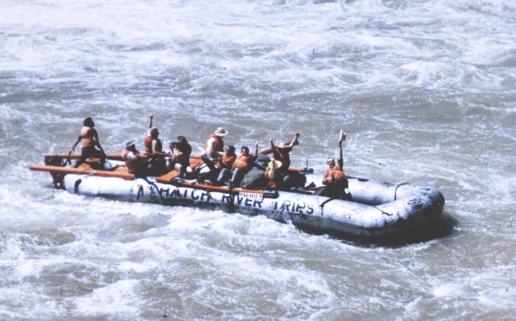 1970's Hatch guests wave after rapid. 