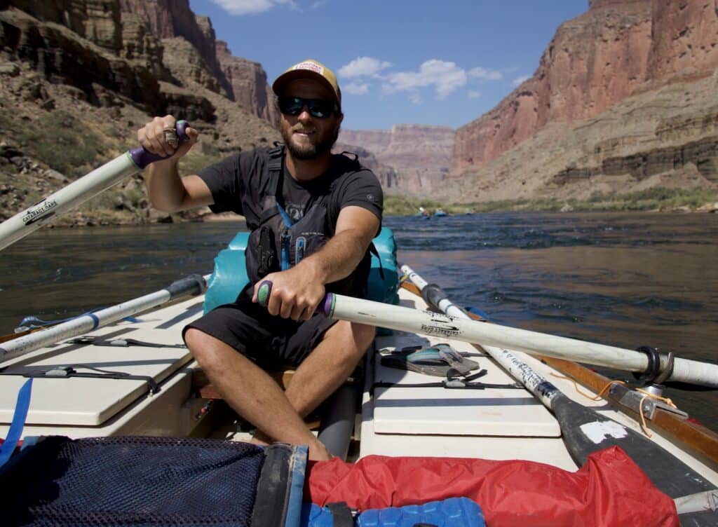 Sean Hatch rowing a boat on the Colorado River. 