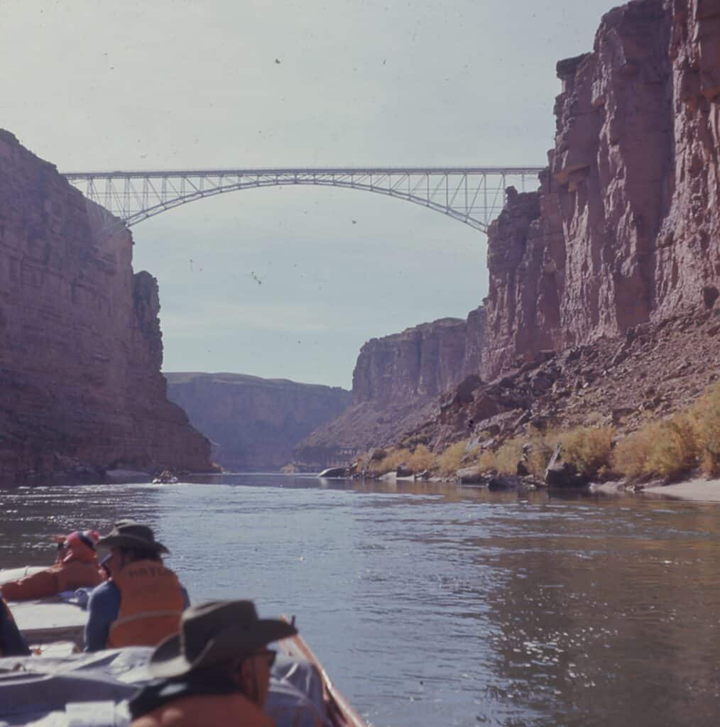 An old photo of the Navajo Bridge from the river. 