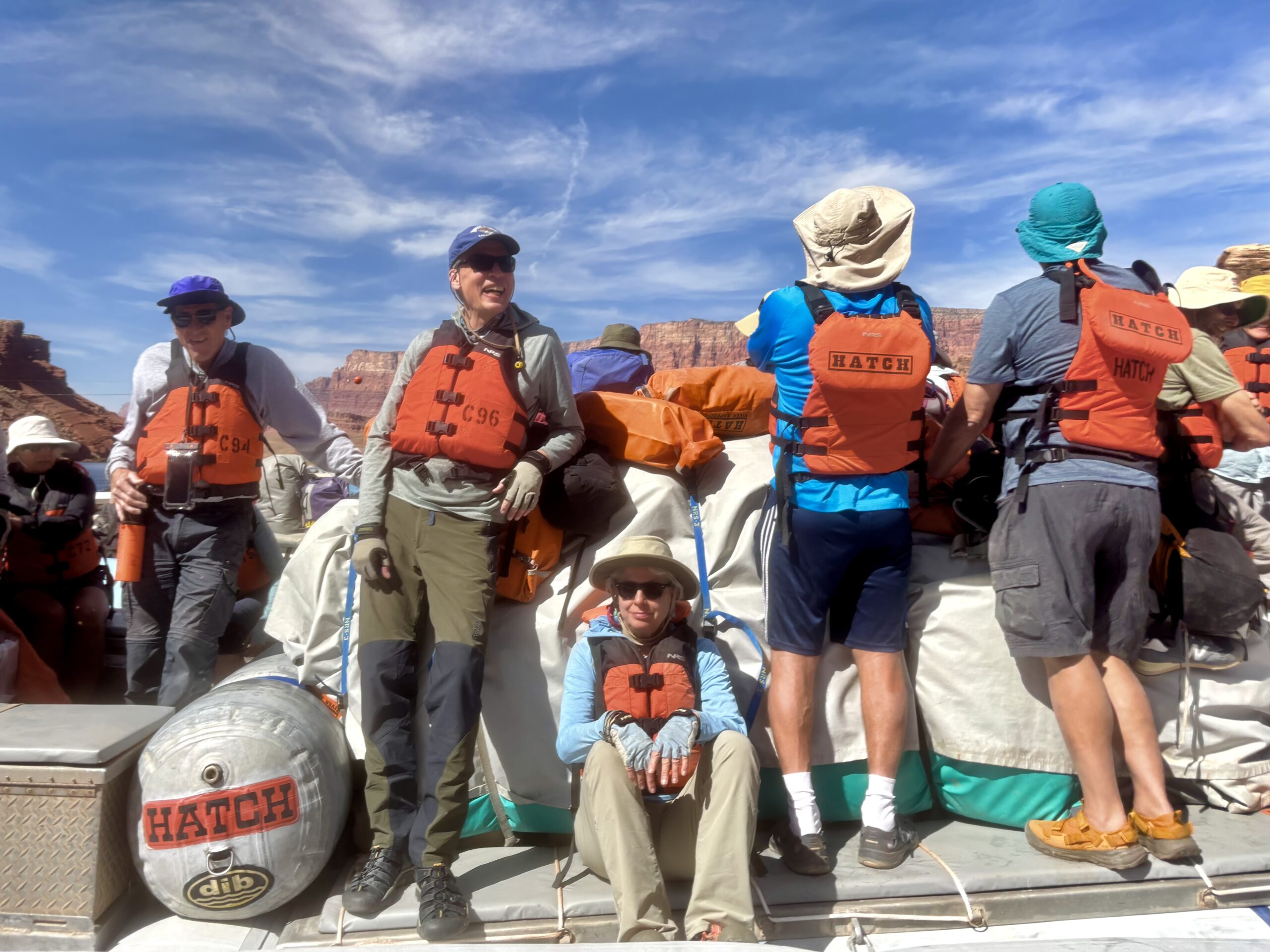 Hatch guests stand and sit around the duffel pile of their Hatch raft. Photo credit: Kurt R.
