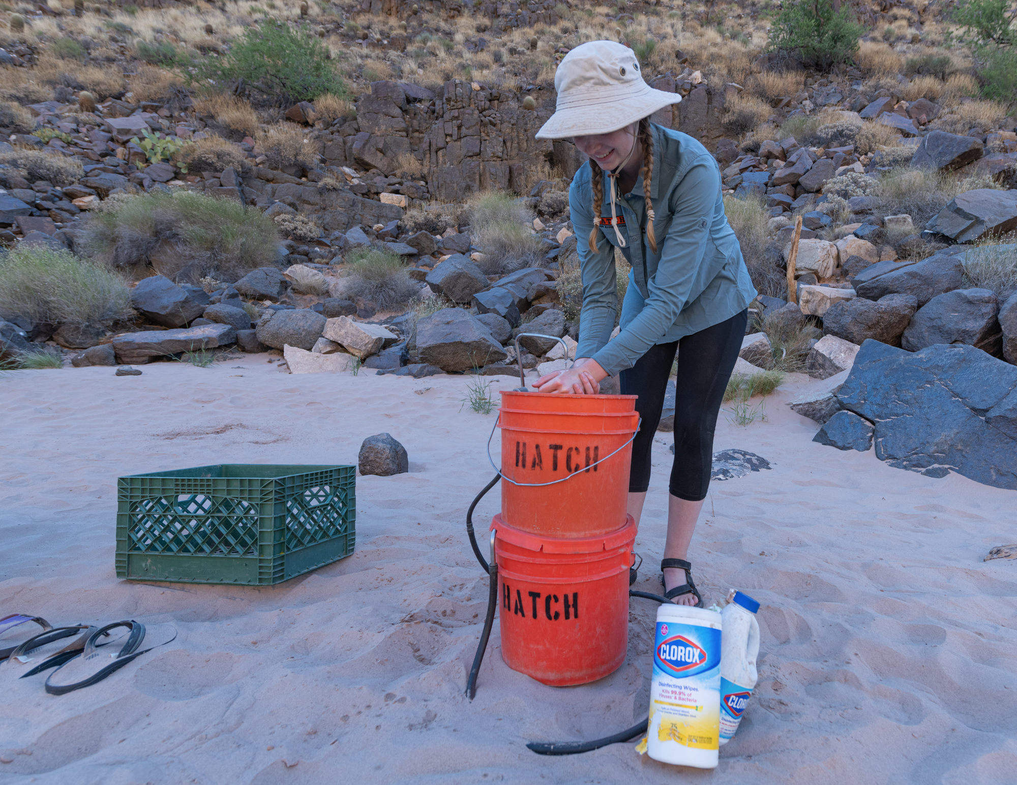 PhotoIntern2023C2-Storey-Web-22 A Hatch guest washes her hands, demonstrating how to maintain good hygiene on your rafting trip. Photo credit: Storey Welch.