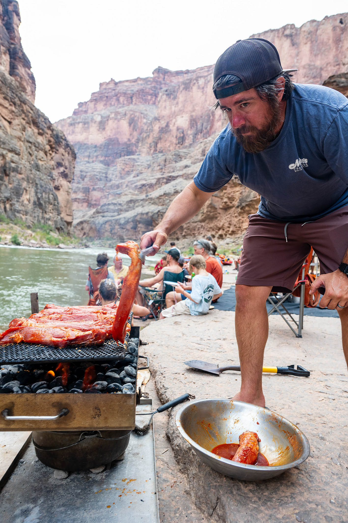 The best way to see the Grand Canyon is where someone else (like this Hatch guide) cooks for you at your camp beside the river. Photo credit: Michael Neumann.