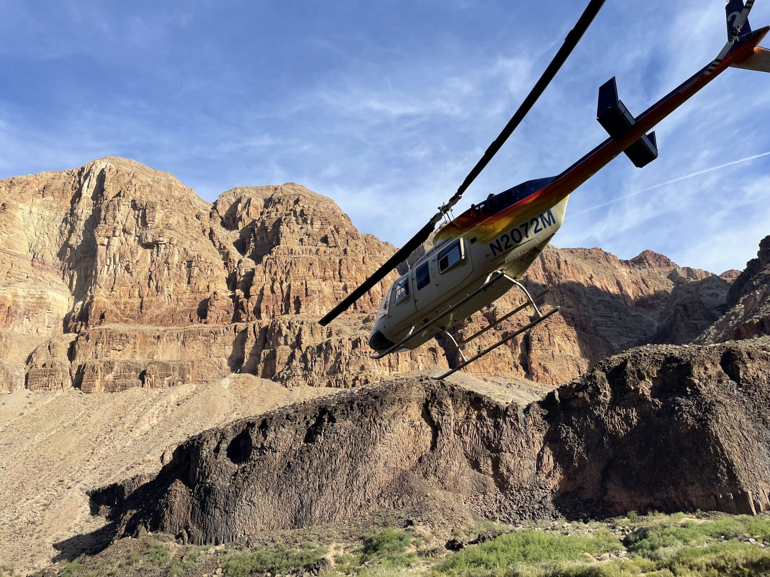 A helicopter flies out of the Grand Canyon carrying Hatch passengers. Hatch trips camp at Whitmore Wash and are the first to board the helicopters and exit the canyon. Photo credit: John Dillon.