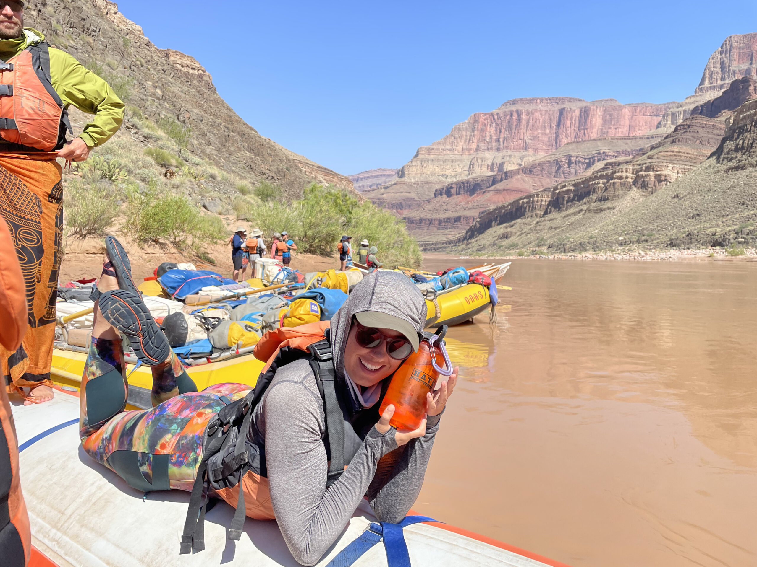 A Hatch guest poses holding their water bottle beside their face. Photo credit: Kiki True