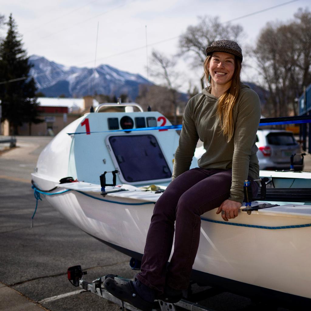 Kelsey Pfendler poses on her ocean row boat as she prepares for her solo ocean row across the Pacific Ocean.