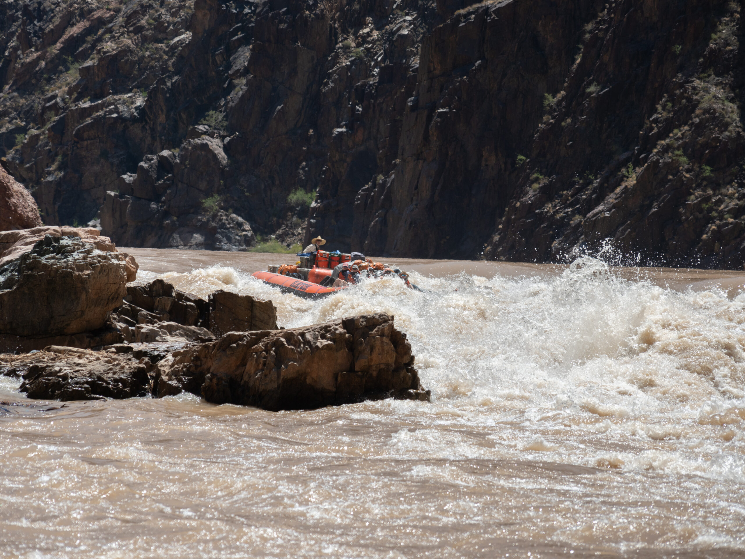 A Hatch raft navigates a rapid formed around a rock outcrop. Photo credit: Amy Horn. 