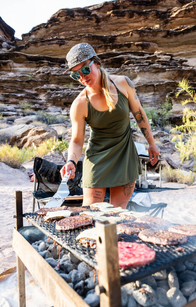 Hatch River Expeditions guide cooking dinner at a Grand Canyon river camp