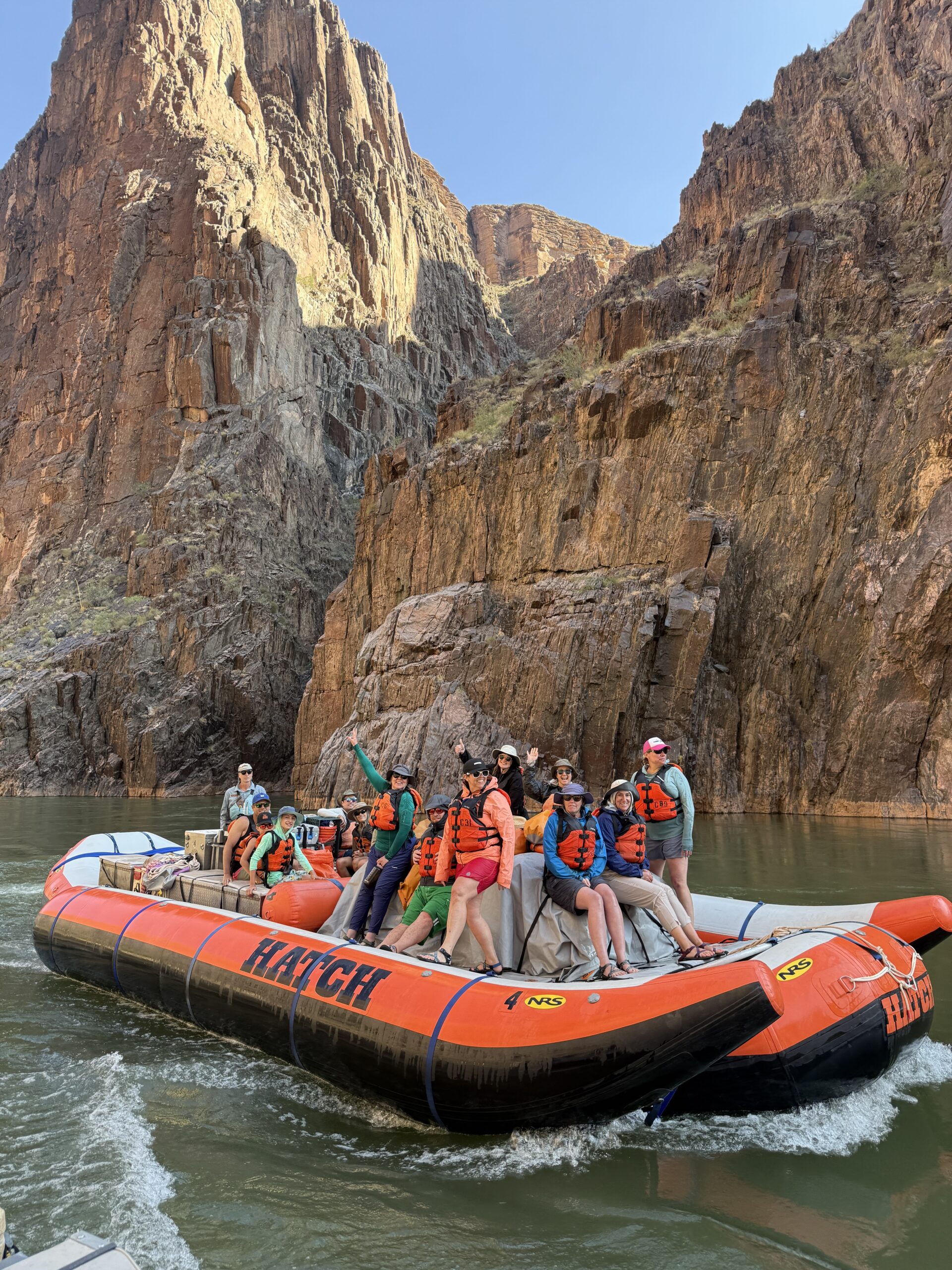 People riding on a motorized raft on a Grand Canyon River Trip. Photo credit: Andy Hawk.