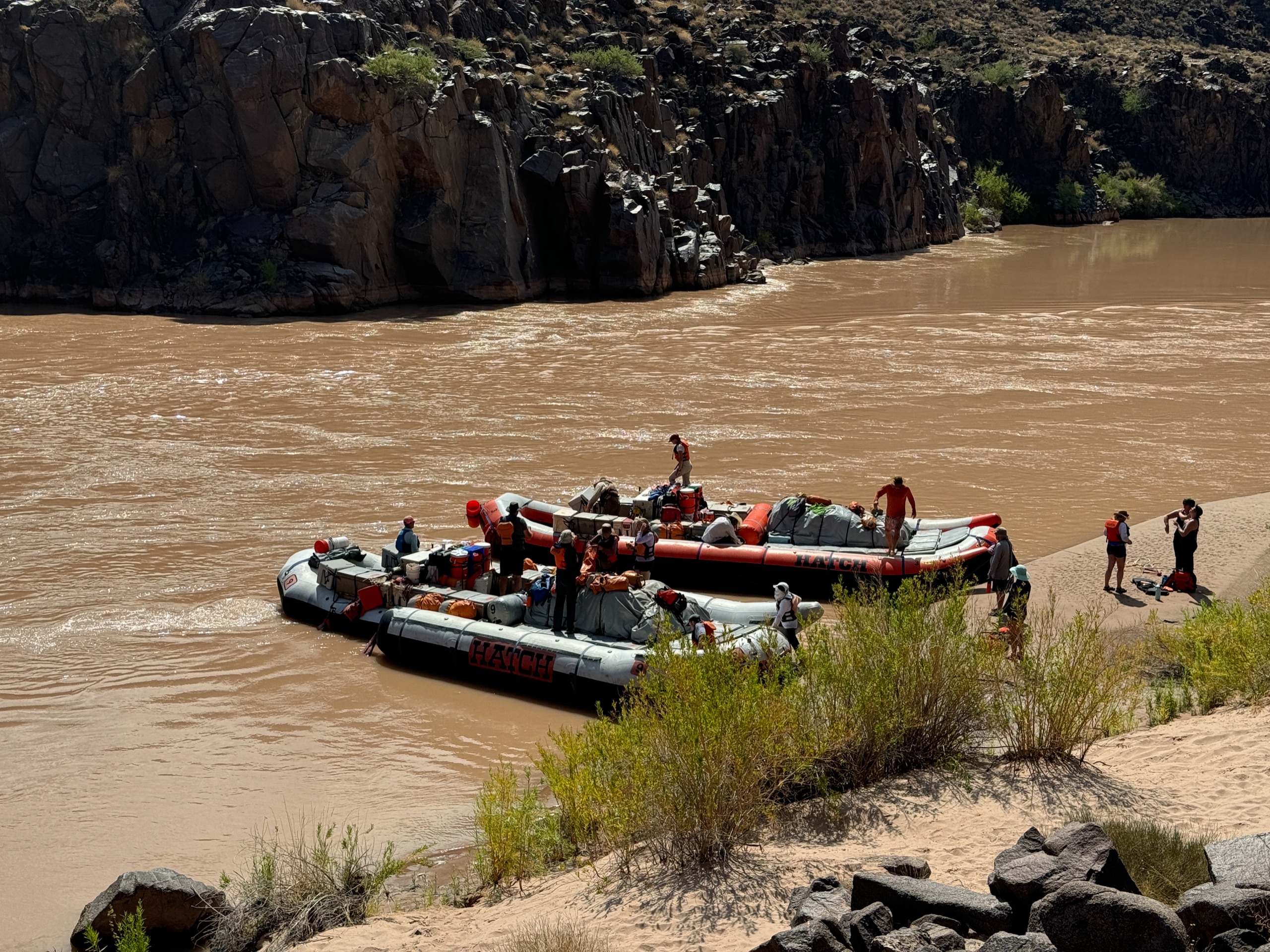 Two Hatch motorized rafts tied up at a sandy beach for a stop on the Colorado River